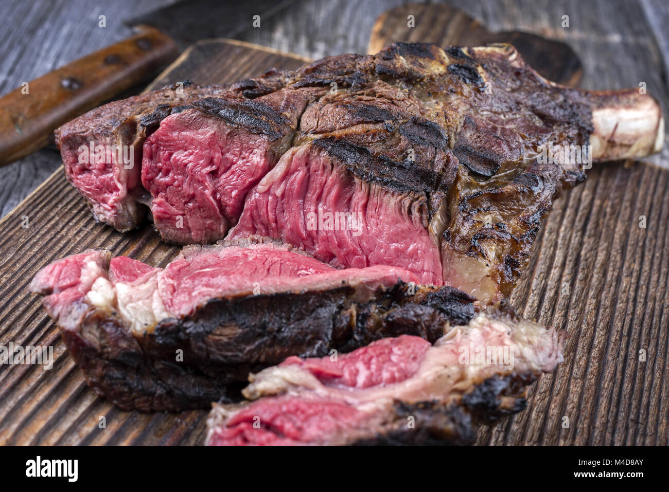 Barbecue Tomahawk Steak on old Cutting Board Stock Photo