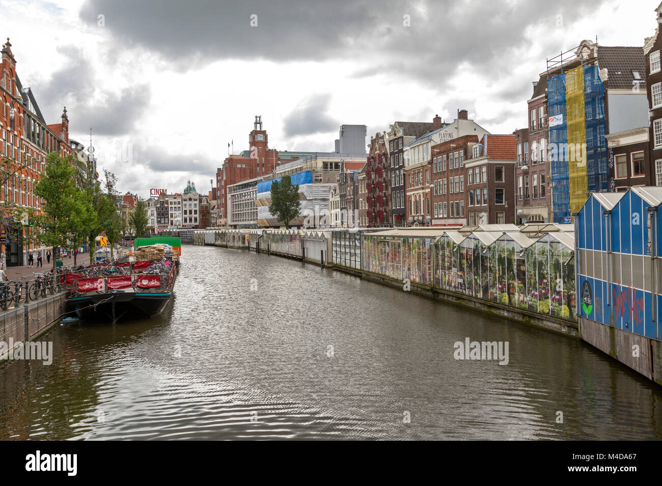 Canal view with the popular floating flower market on one side and ferry for bikes on the other. Stock Photo