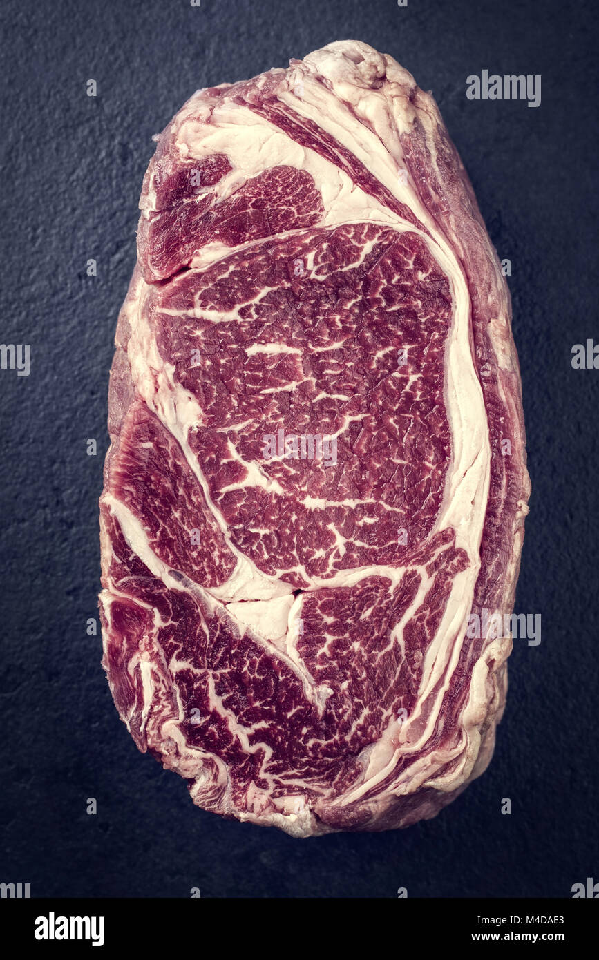 Raw dry aged Entrecote Steak as Vintage on a slate Stock Photo