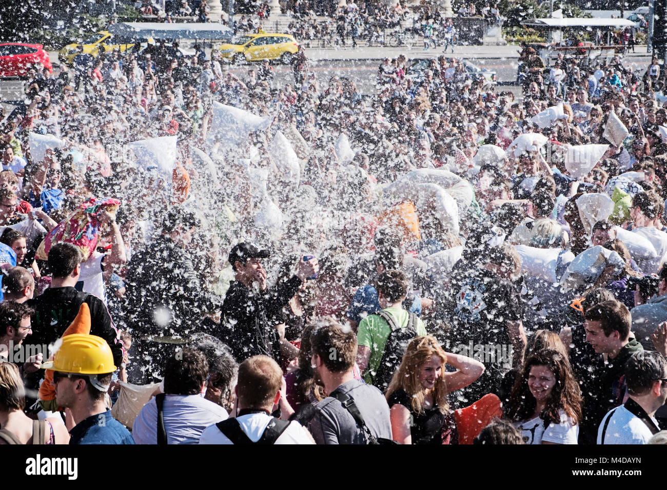 BUDAPEST, HUNGARY - APRIL 1, 2017:  Feathers from a down pillow fly through the air during the festivities of International Pillow Fight Day in Hungar Stock Photo