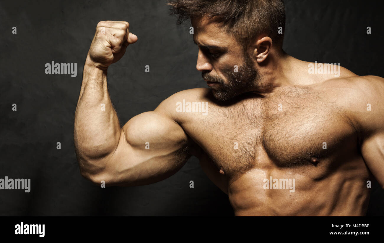 Arm and Torso of Muscular Male Bodybuilder Flexing Biceps Stock