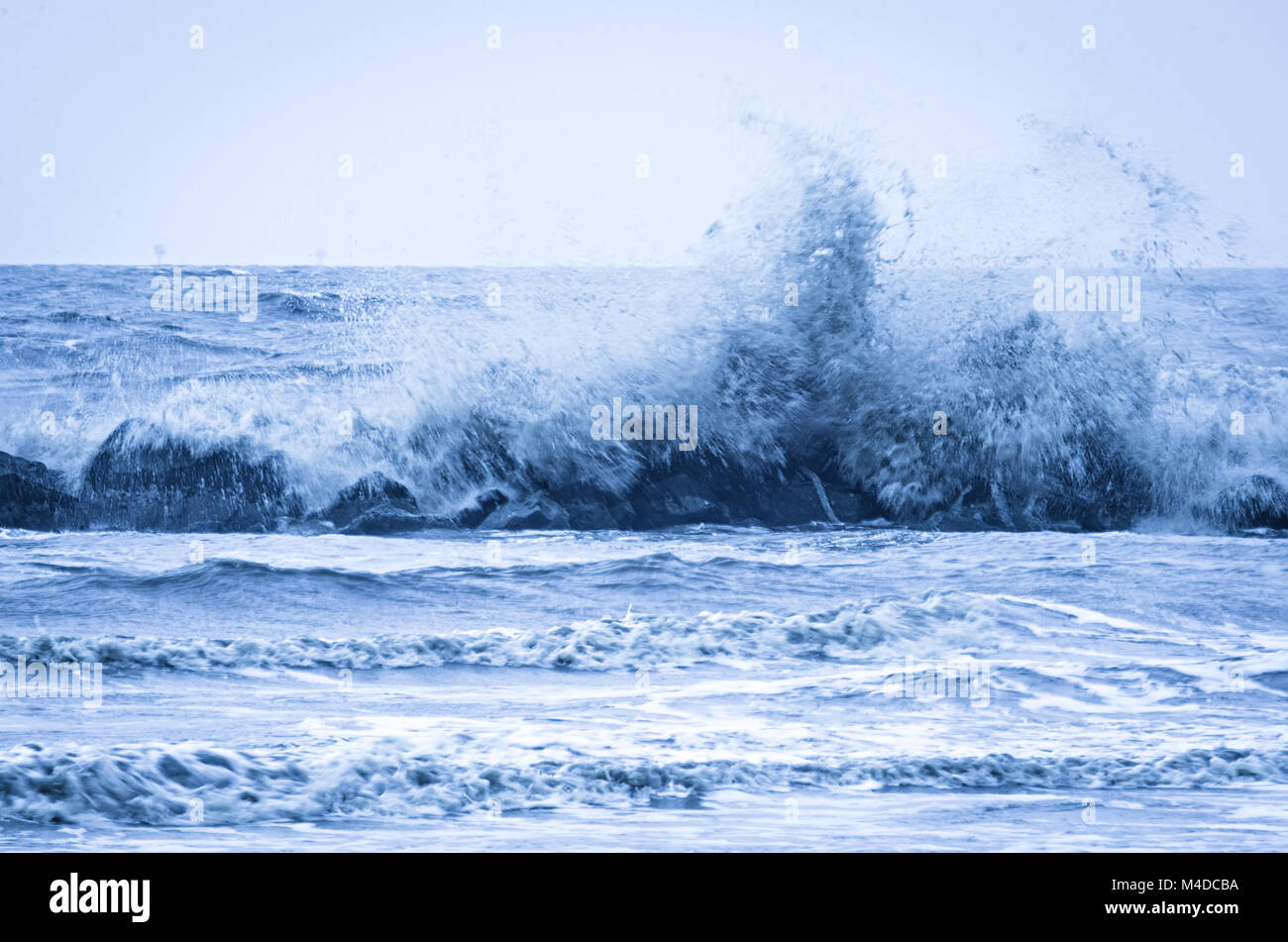 wave crashing into wavaebreaker on louisiana gulf coast Stock Photo