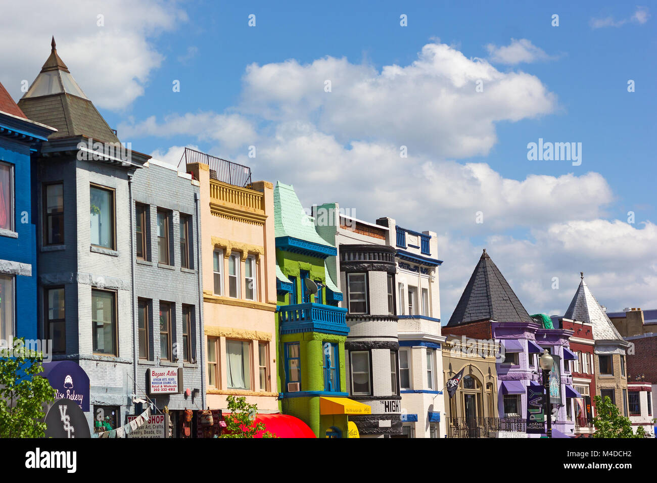 WASHINGTON DC, USA – MAY 9, 2015: Vibrant buildings colors of shops and eateries in Adams Morgan neighborhood on a sunny spring day on the street of t Stock Photo