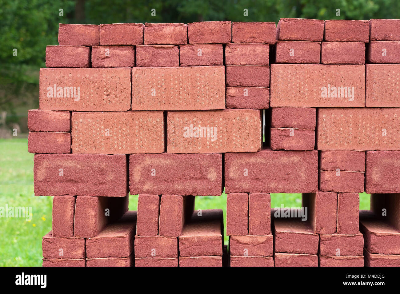 Stack of piled red bricks outside Stock Photo