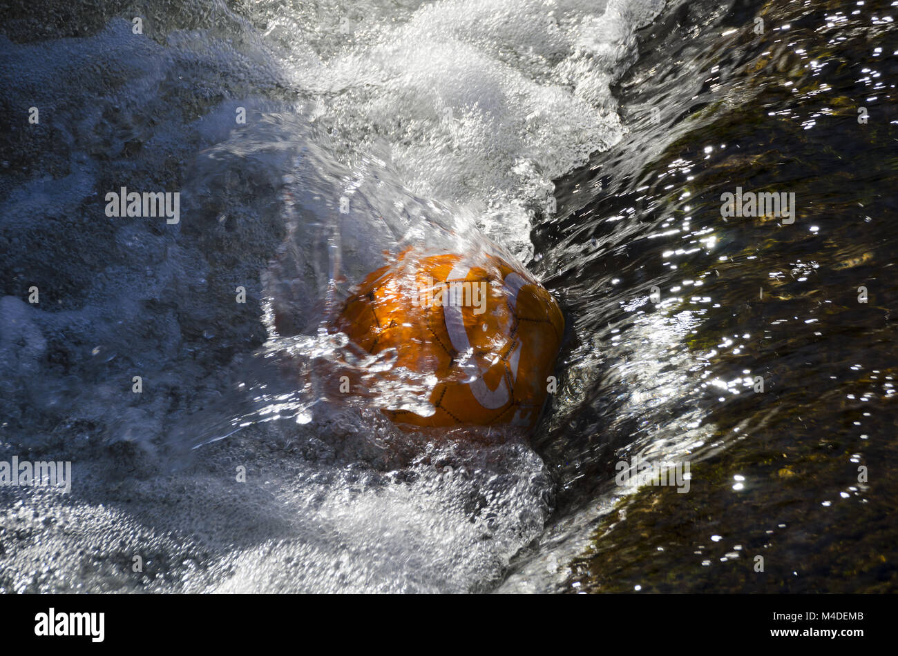 soccer ball caught in water Stock Photo