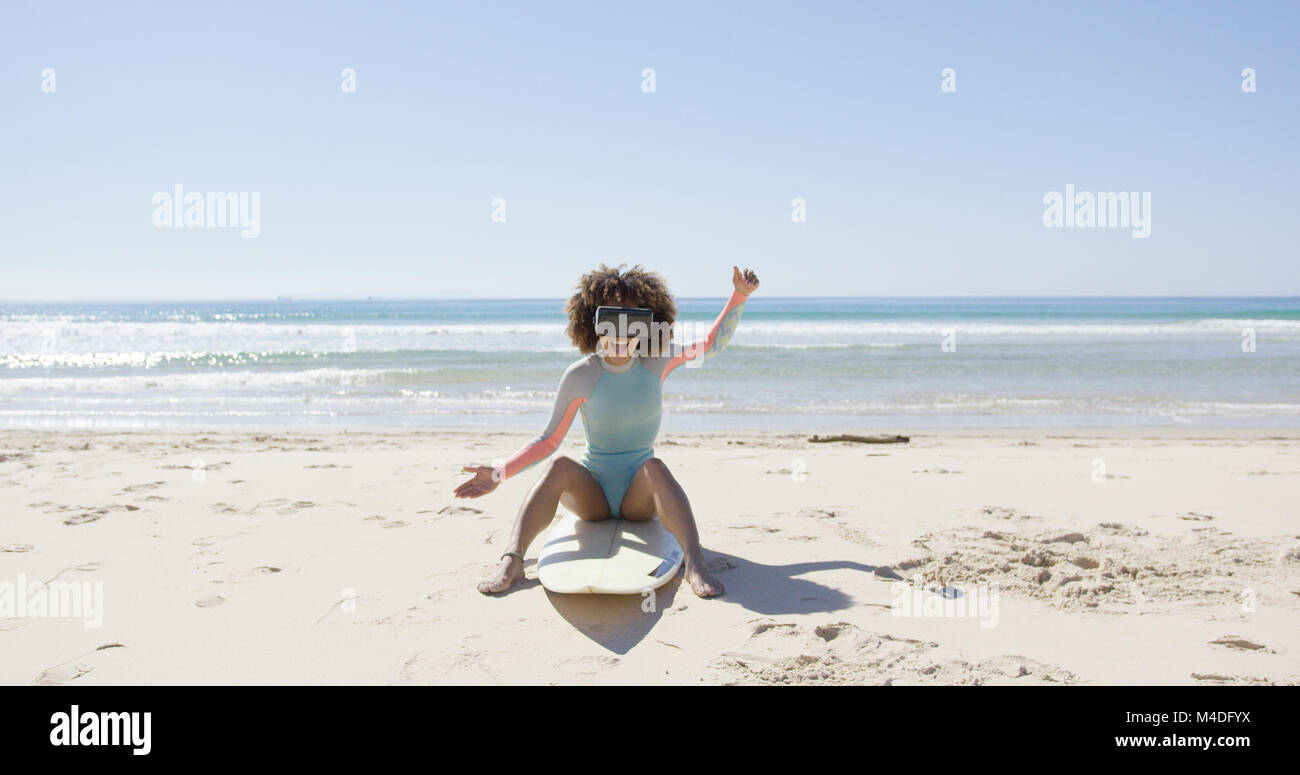 Female on beach wearing virtual reality glasses Stock Photo