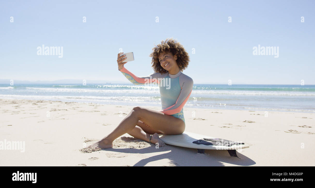 Female taking selfie on beach Stock Photo