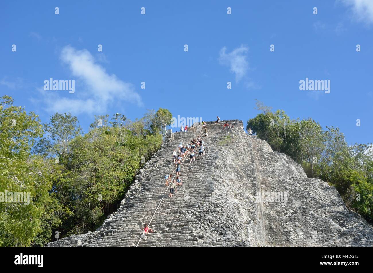 Tourists climbing  stone Temple at Coba Yucatan Mexico Stock Photo