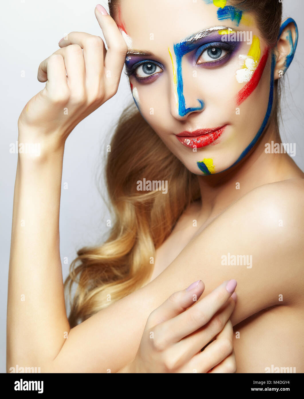 Young female painter with acrylic paint on face Stock Photo - Alamy