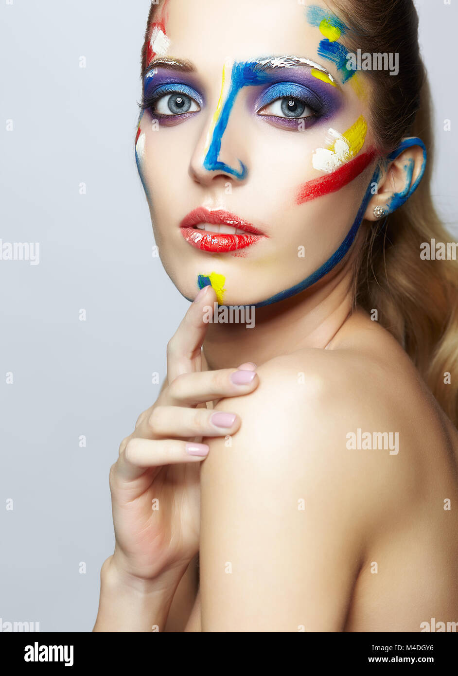 Young female painter with acrylic paint on face Stock Photo Alamy