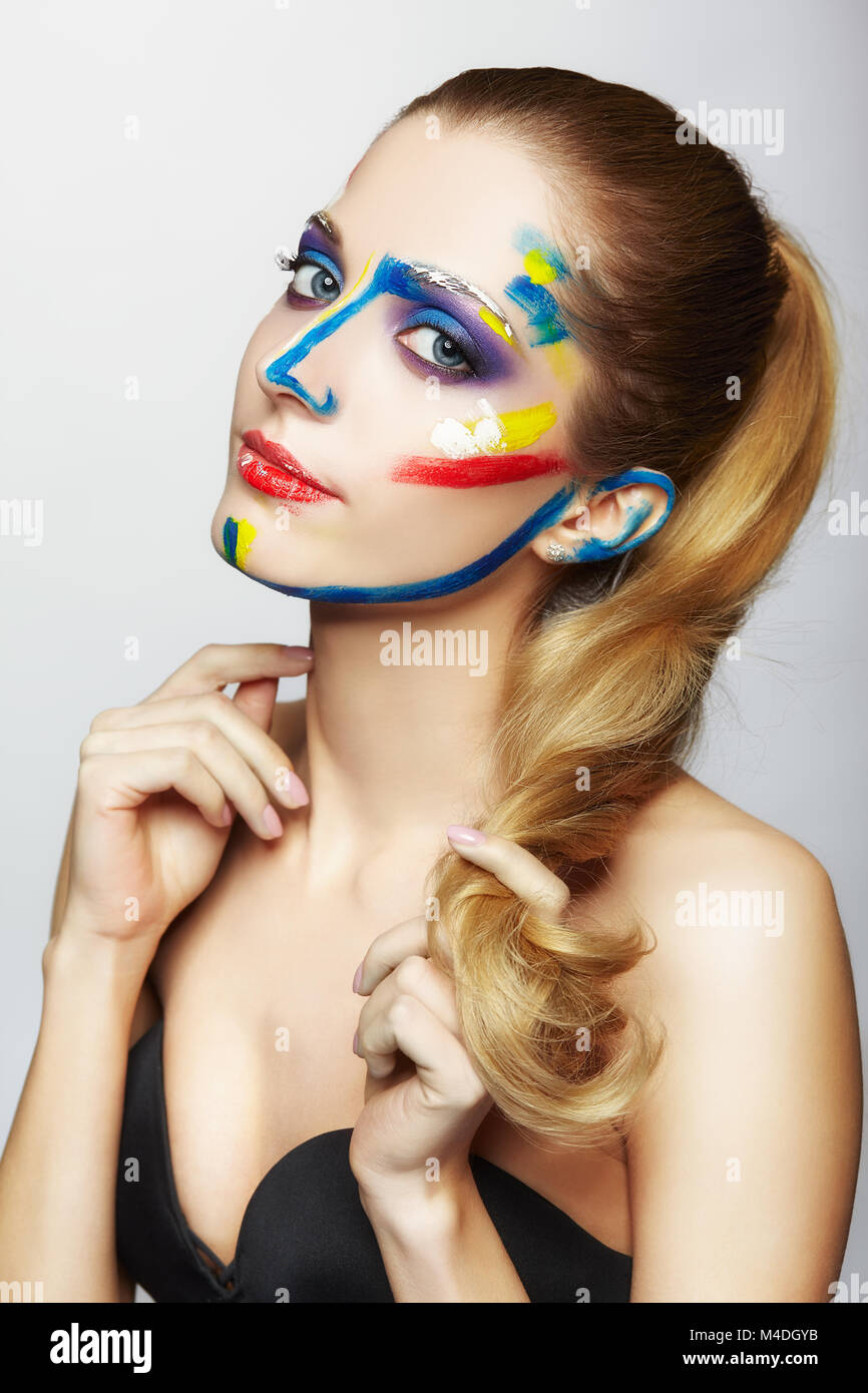 Young female painter with acrylic paint on face Stock Photo - Alamy