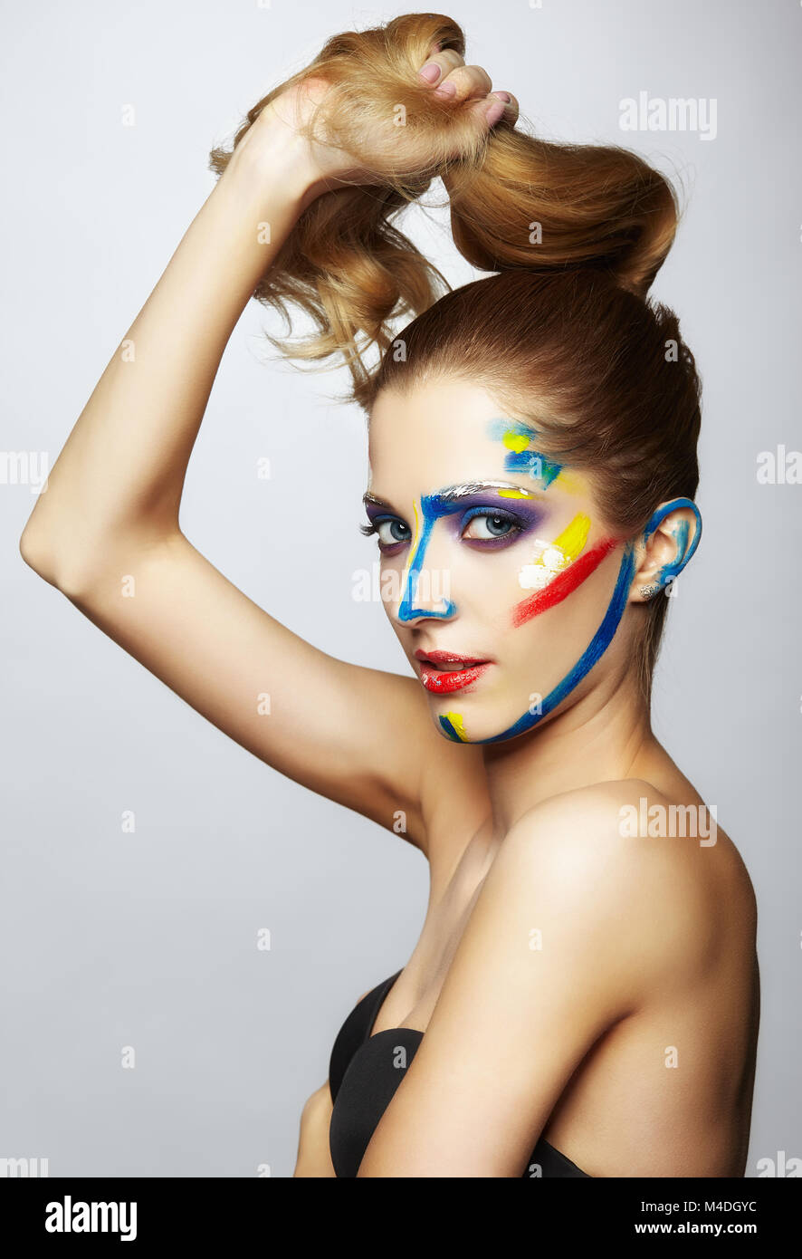 Young female painter with acrylic paint on face Stock Photo - Alamy