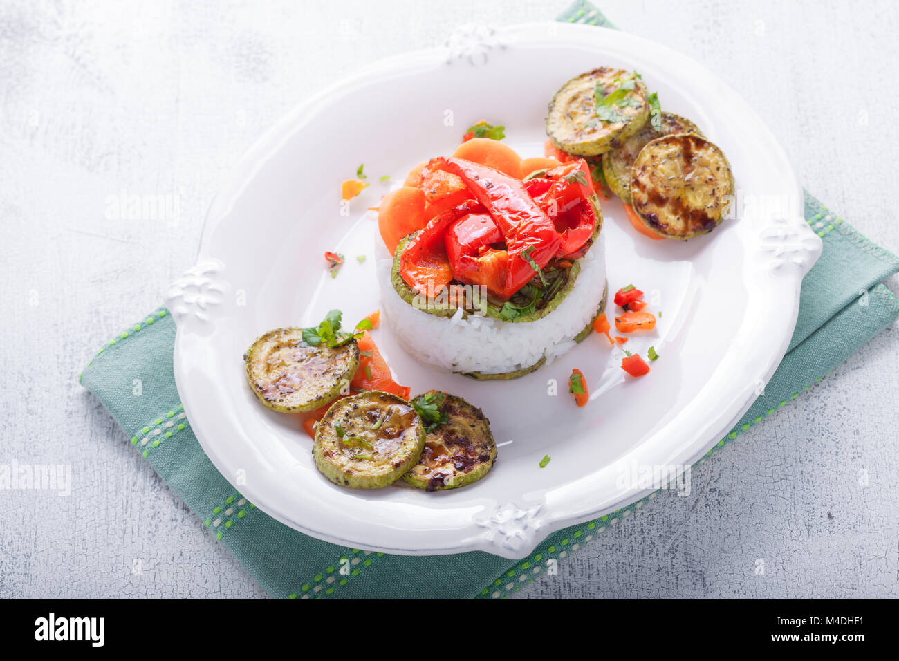Rice timbale with fried zucchini, peppers, carrots Stock Photo Alamy
