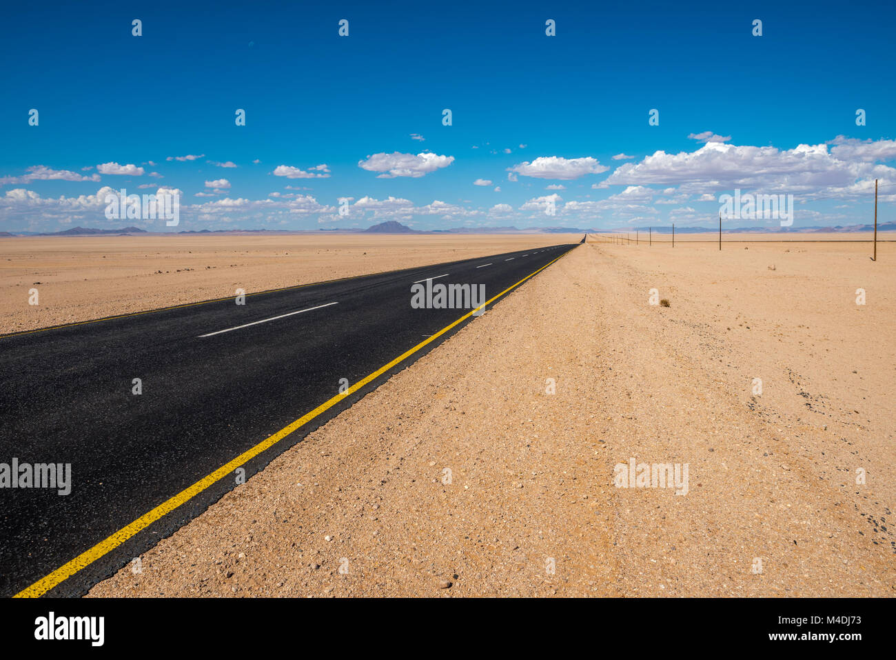vibrant image of highway and blue cloudy sky Stock Photo - Alamy