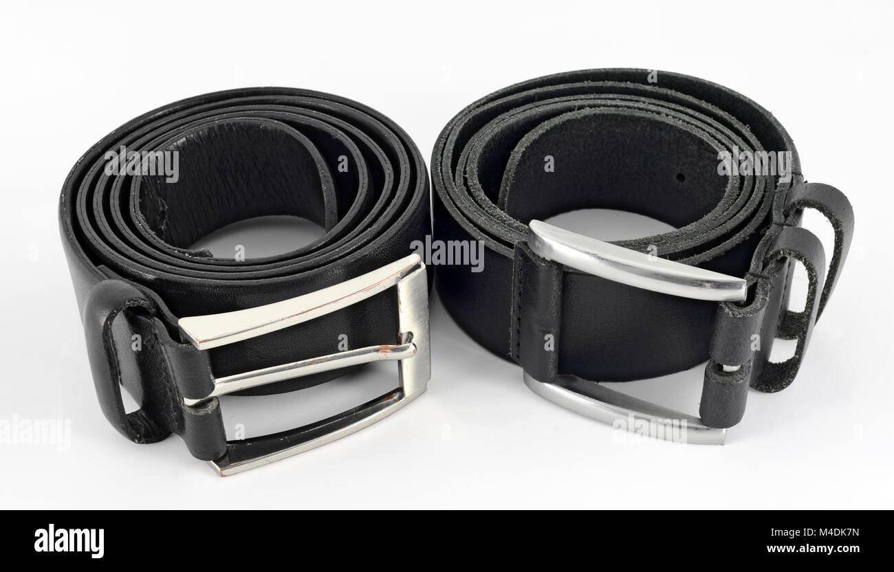 rolled up used black leather belts Stock Photo