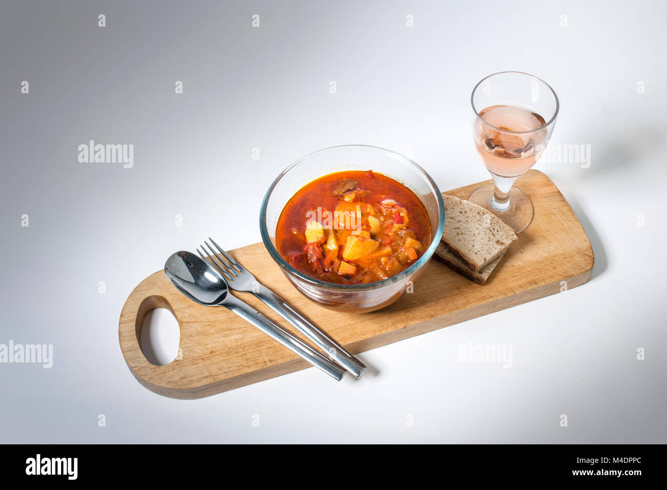 Goulash served with bread and rose wine Stock Photo