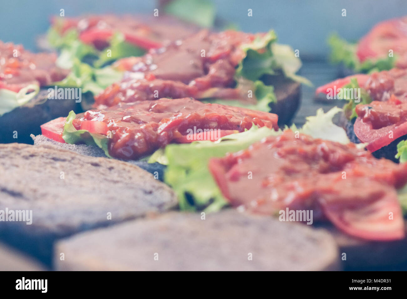 Ketchup salad cucumber on a burger roll baking process Stock Photo Alamy