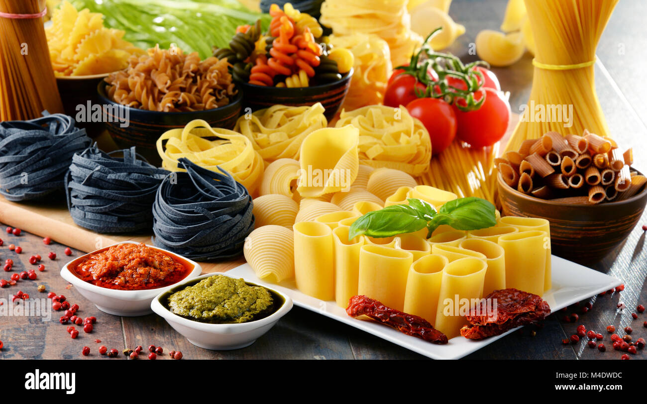Composition with different sorts of pasta on kitchen table Stock Photo