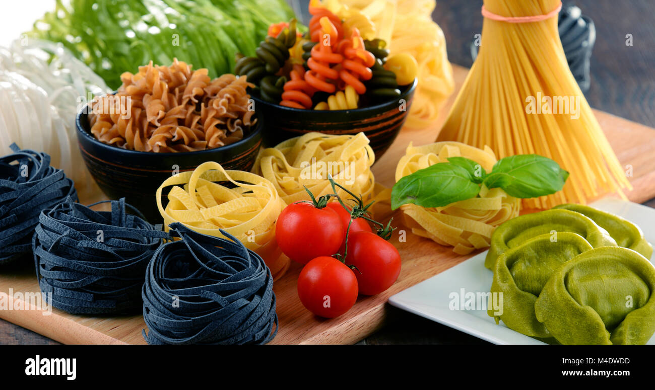Composition with different sorts of pasta on kitchen table Stock Photo