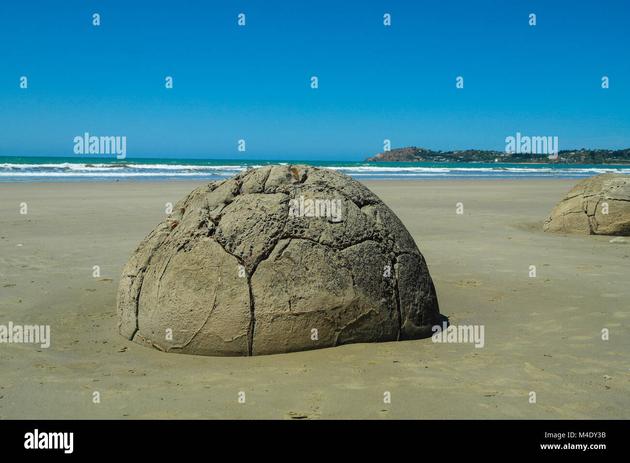 60 million year old giant ball shaped boulder on the beach at Moeraki South  Island New Zealand Stock Photo - Alamy