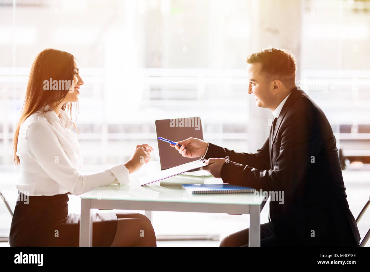 Business man and business woman sign a contract. Satisfied with 