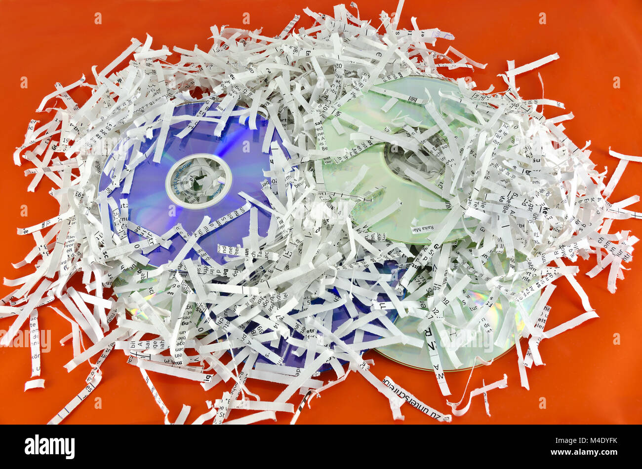 storage discs and shredded paper sheets Stock Photo