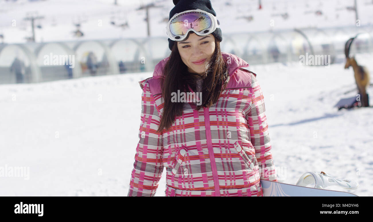 Young asian female snowboarder hi-res 