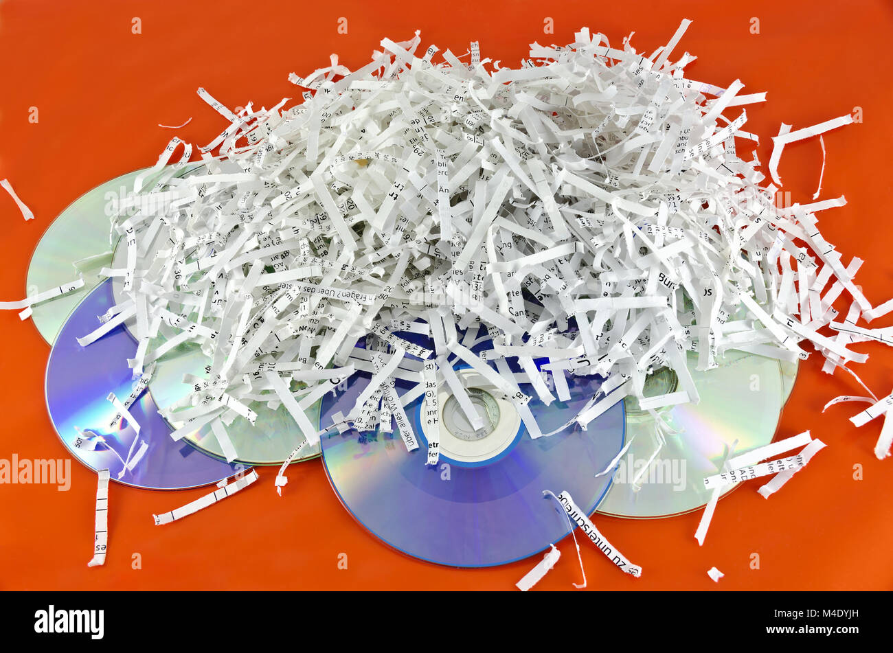 storage discs and shredded paper sheets Stock Photo
