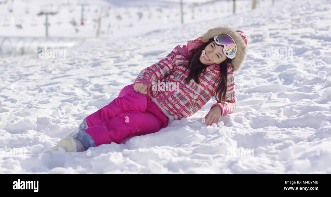 Young woman in pink snowsuit with ski goggles Stock Photo
