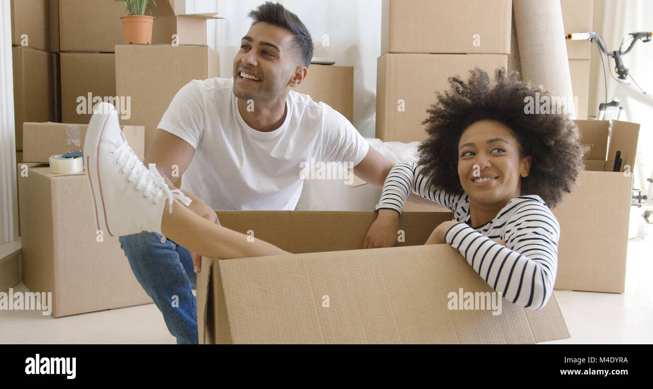 Smiling young woman in a cardboard carton Stock Photo - Alamy