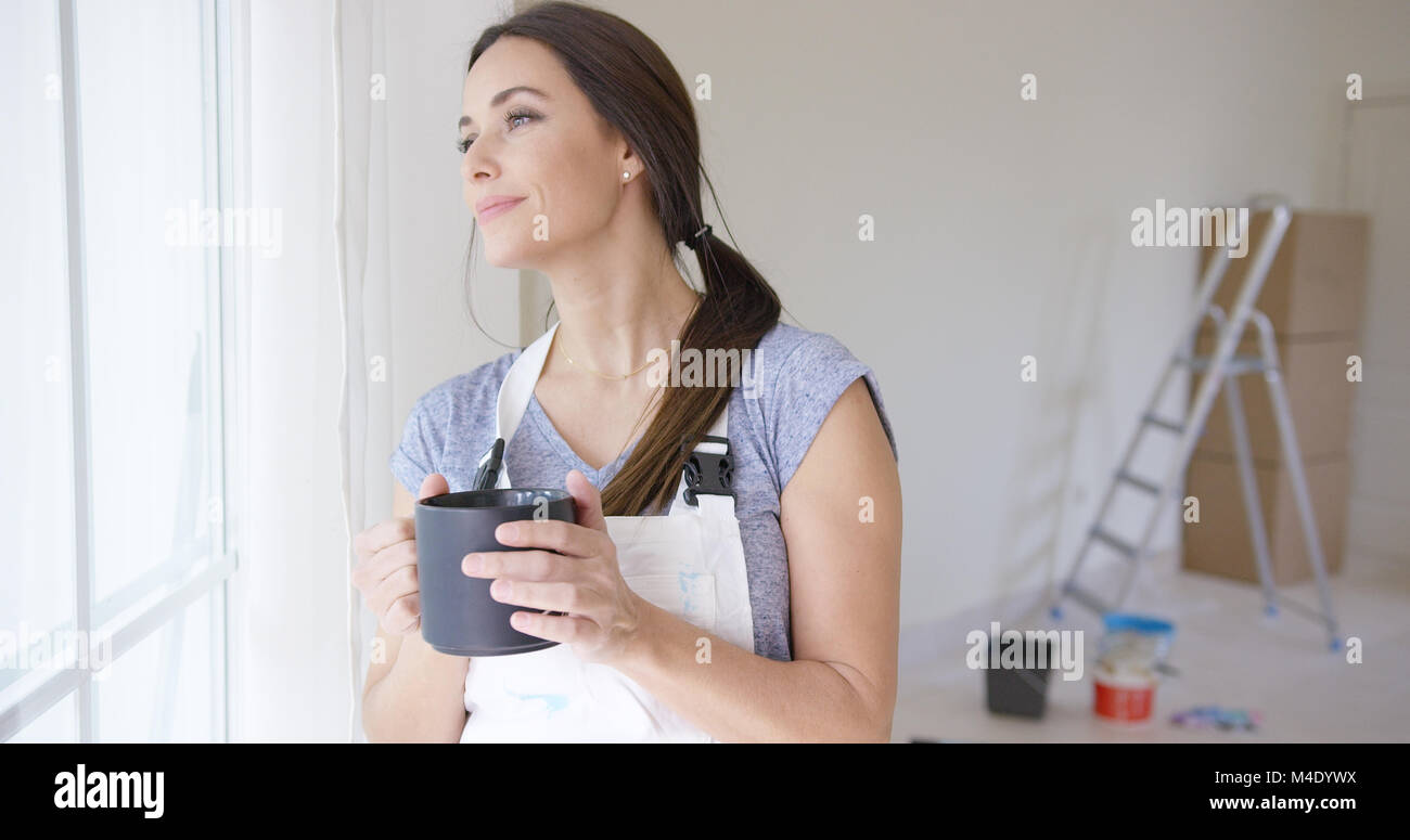 Young woman standing daydreaming Stock Photo