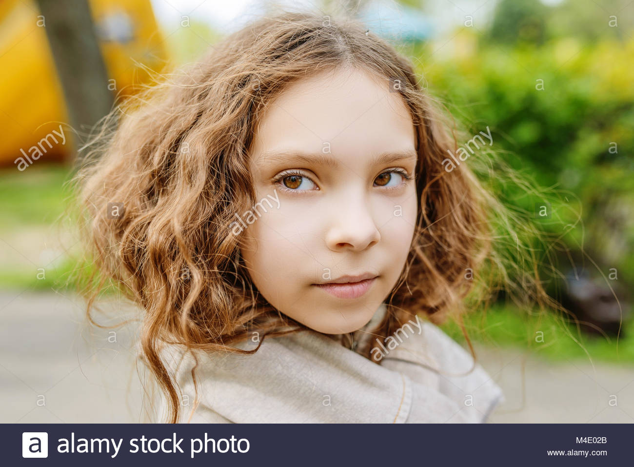 Beautiful Little Girl With Long Wavy Hair Close Up Stock Photo