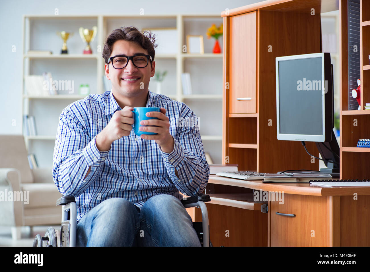Disabled student studying at home on wheelchair Stock Photo - Alamy