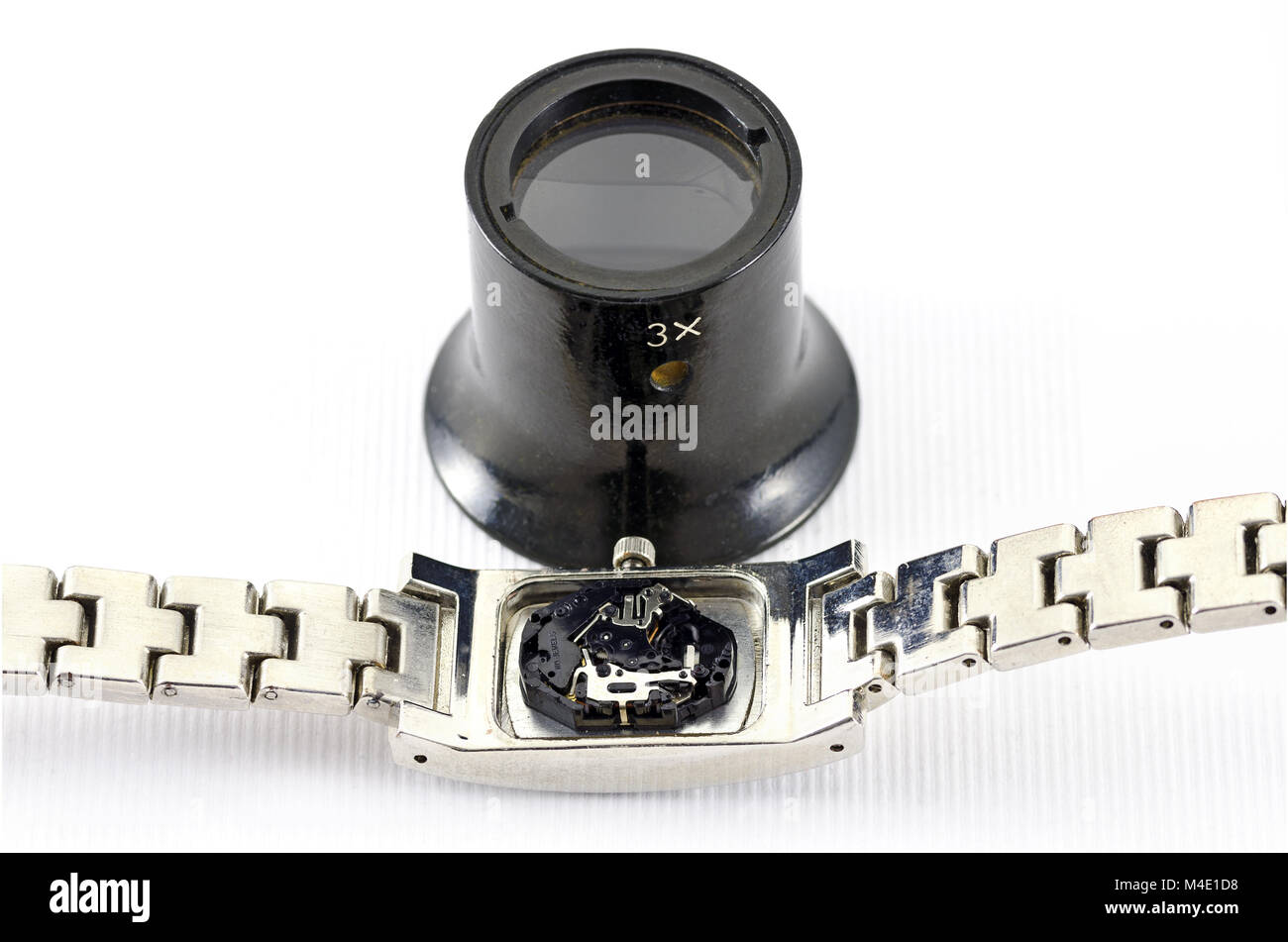 digital mechanism of a wristwatch and watchmaker loupe Stock Photo