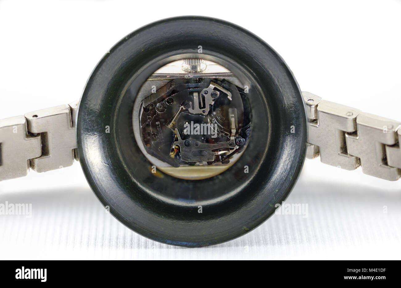 View through a watch maker loupe into a wrist watch Stock Photo
