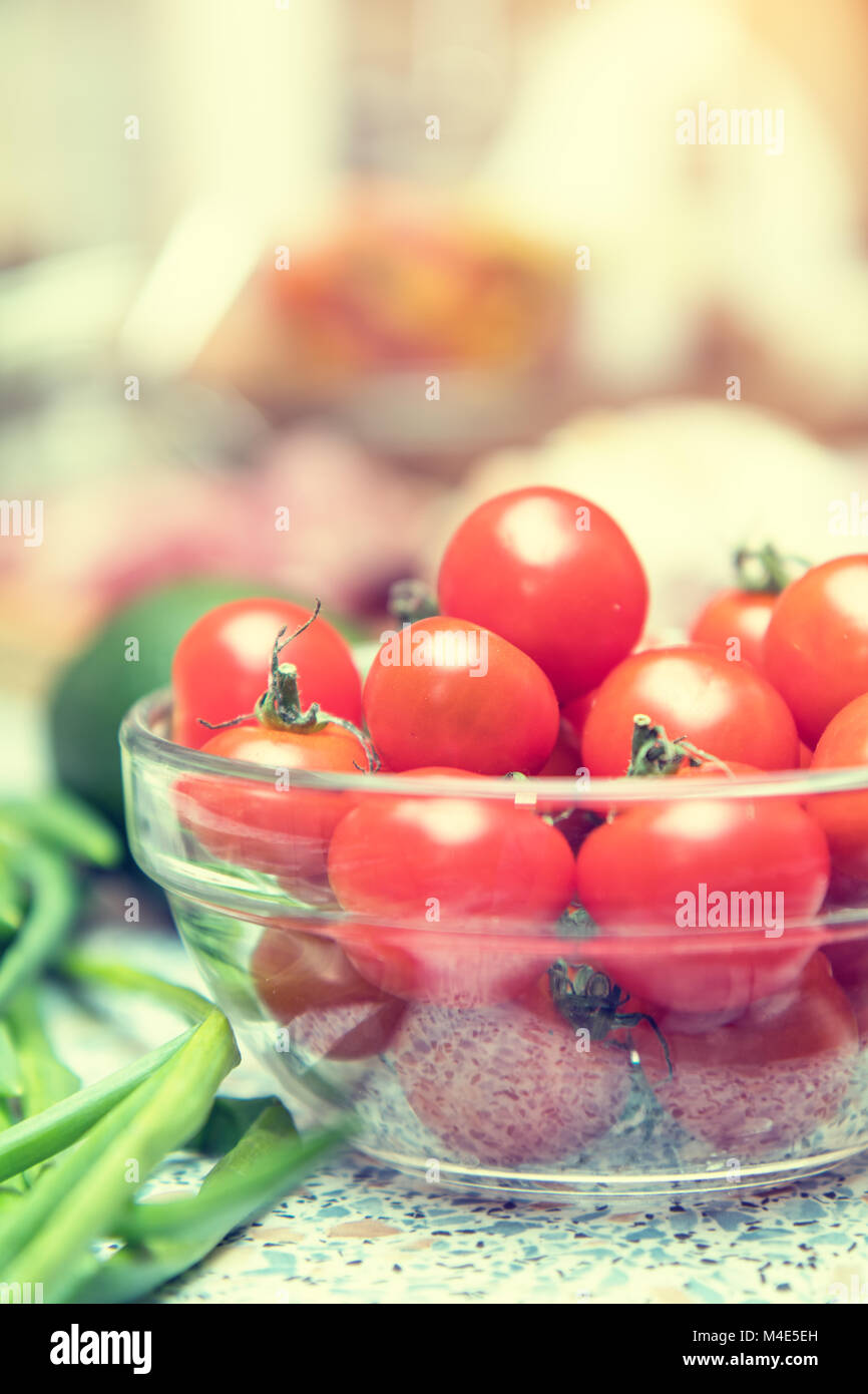 Raw fresh cherry tomatoes in glass bowl Stock Photo - Alamy