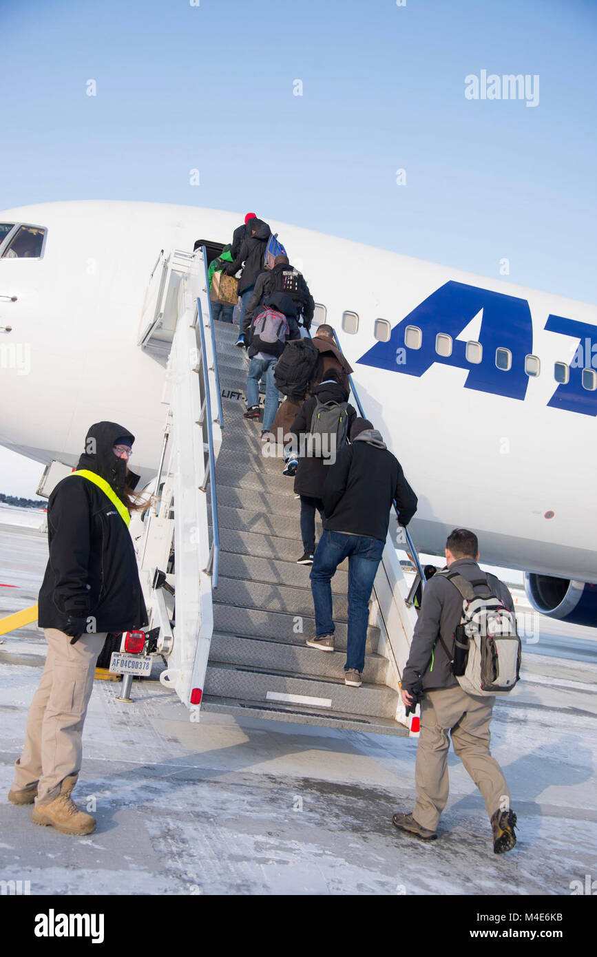 Passengers board the Patriot Express at Misawa Air Base, Japan, Jan. 30, 2018. These customers are the first to utilize the newly renovated Air Mobility Command passenger terminal. The renovations include an expanded family room, new seating, and a surplus of new restrooms. Stock Photo