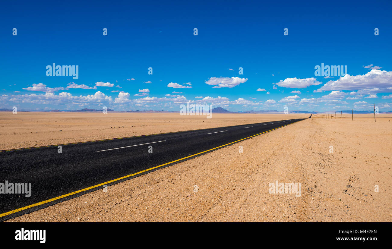 vibrant image of highway and blue cloudy sky Stock Photo - Alamy