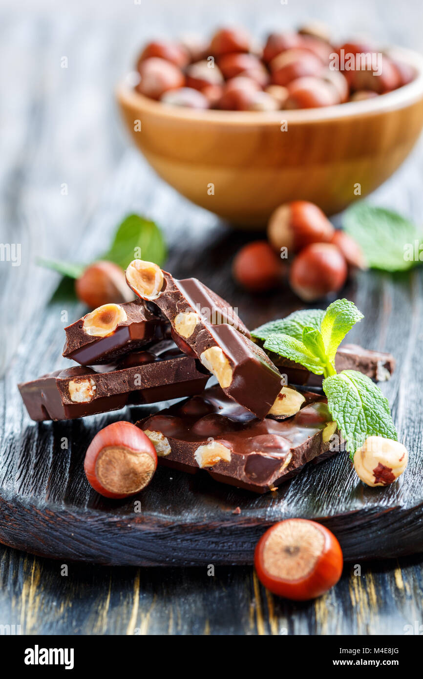 Dark chocolate with hazelnuts and mint leaves. Stock Photo