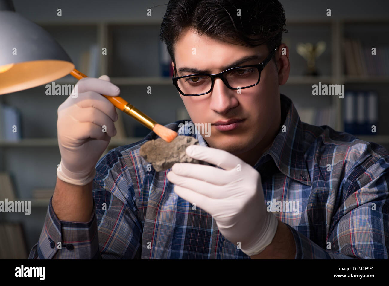Archeologist working late night in office Stock Photo Alamy