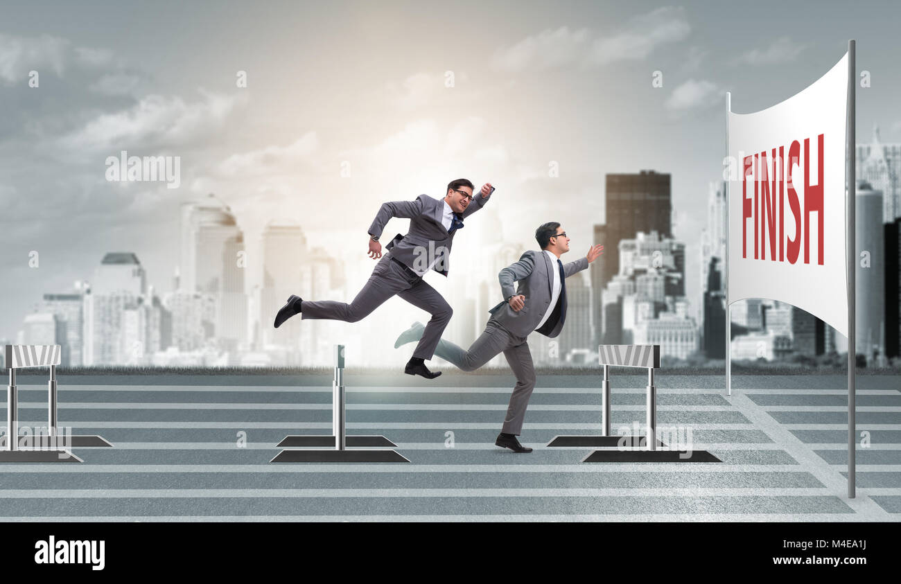 Businessman jumping over barriers in business concept Stock Photo Alamy