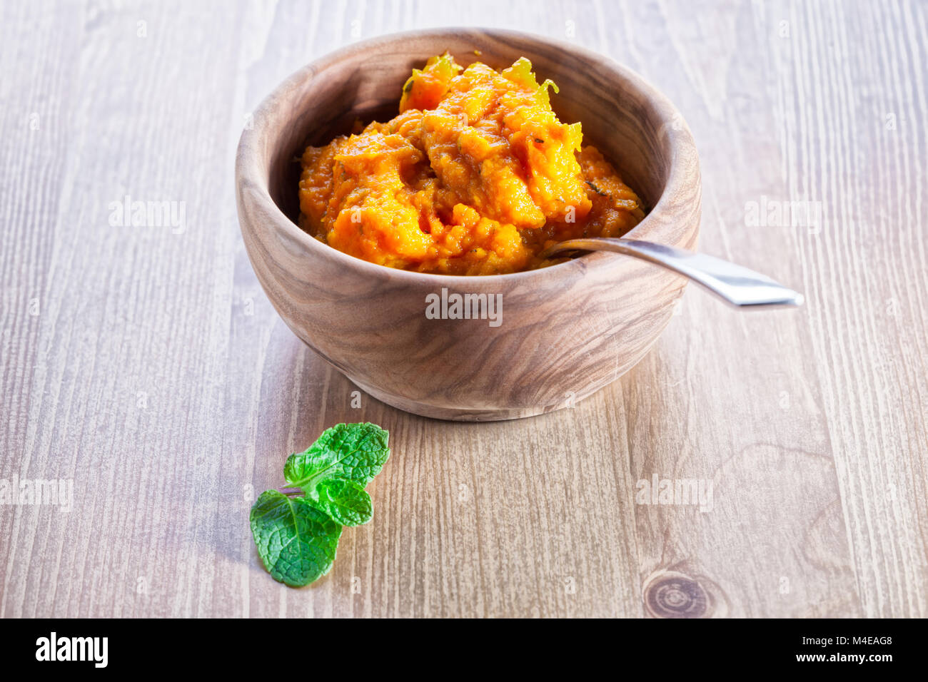 Pumpkin puree with greenery Stock Photo