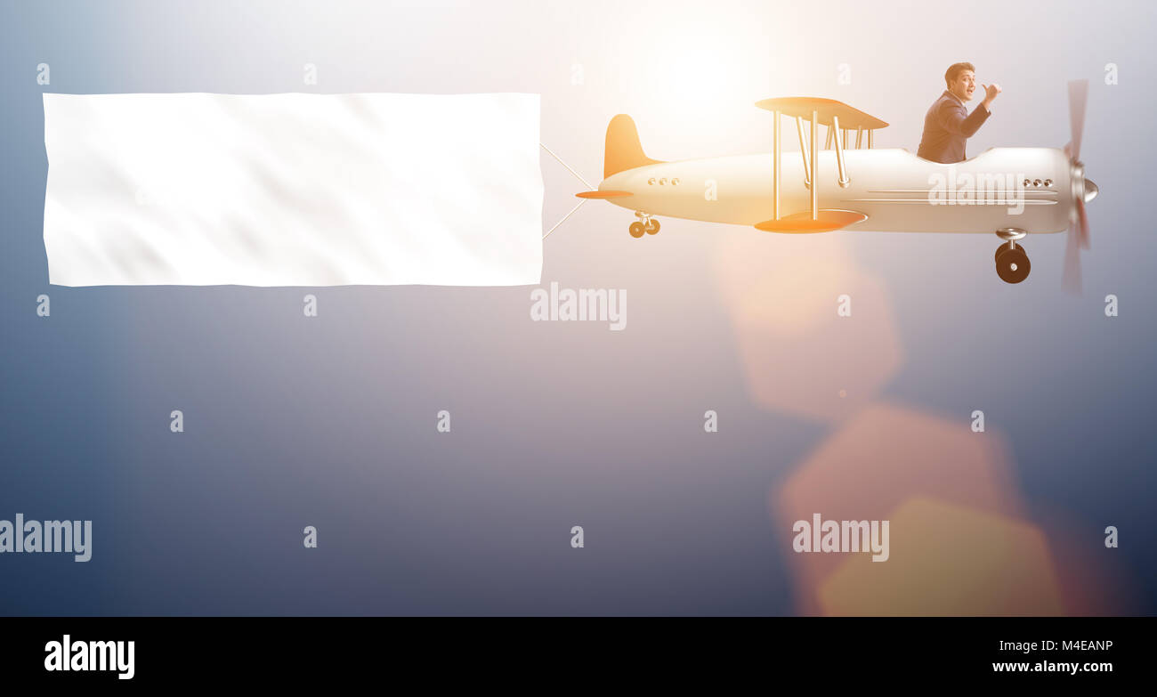 Biplane with businessman and blank banner Stock Photo