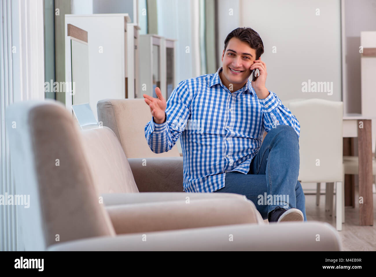 Young man shopping in furniture store Stock Photo - Alamy