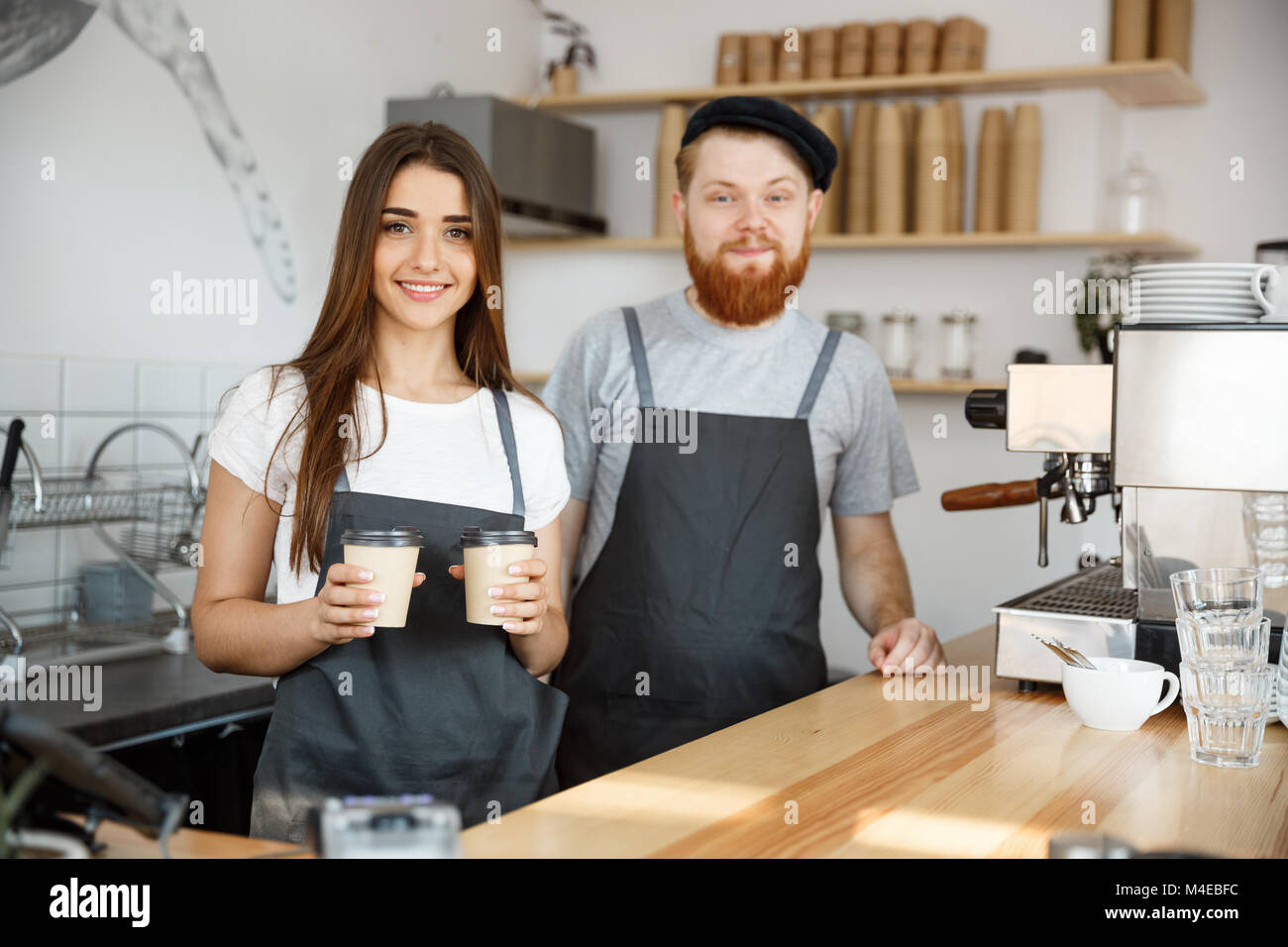 Coffee Business Concept Positive young bearded man and beautiful