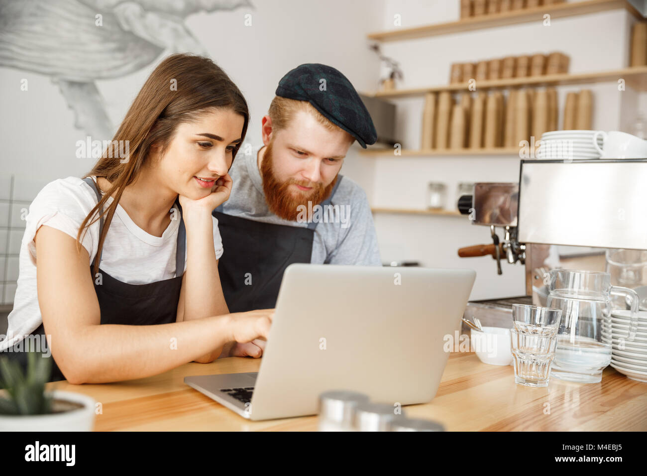 Coffee Business Concept Satisfied and smile owners look on laptop for