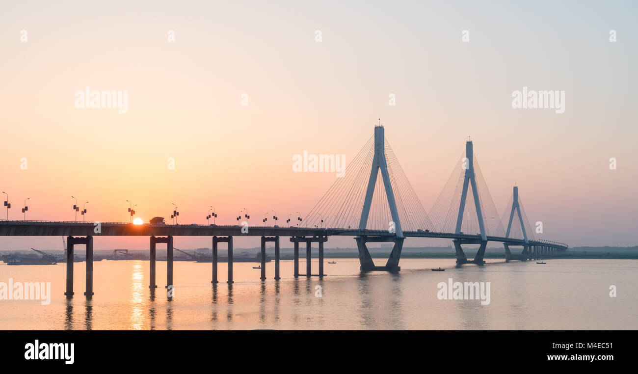 cable stayed bridge with setting sun Stock Photo