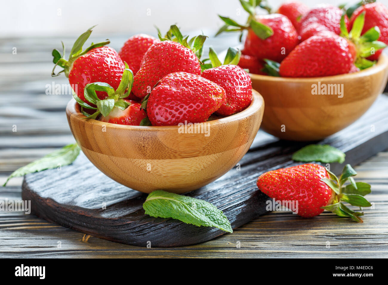 Wooden bowl with ripe strawberries Stock Photo - Alamy