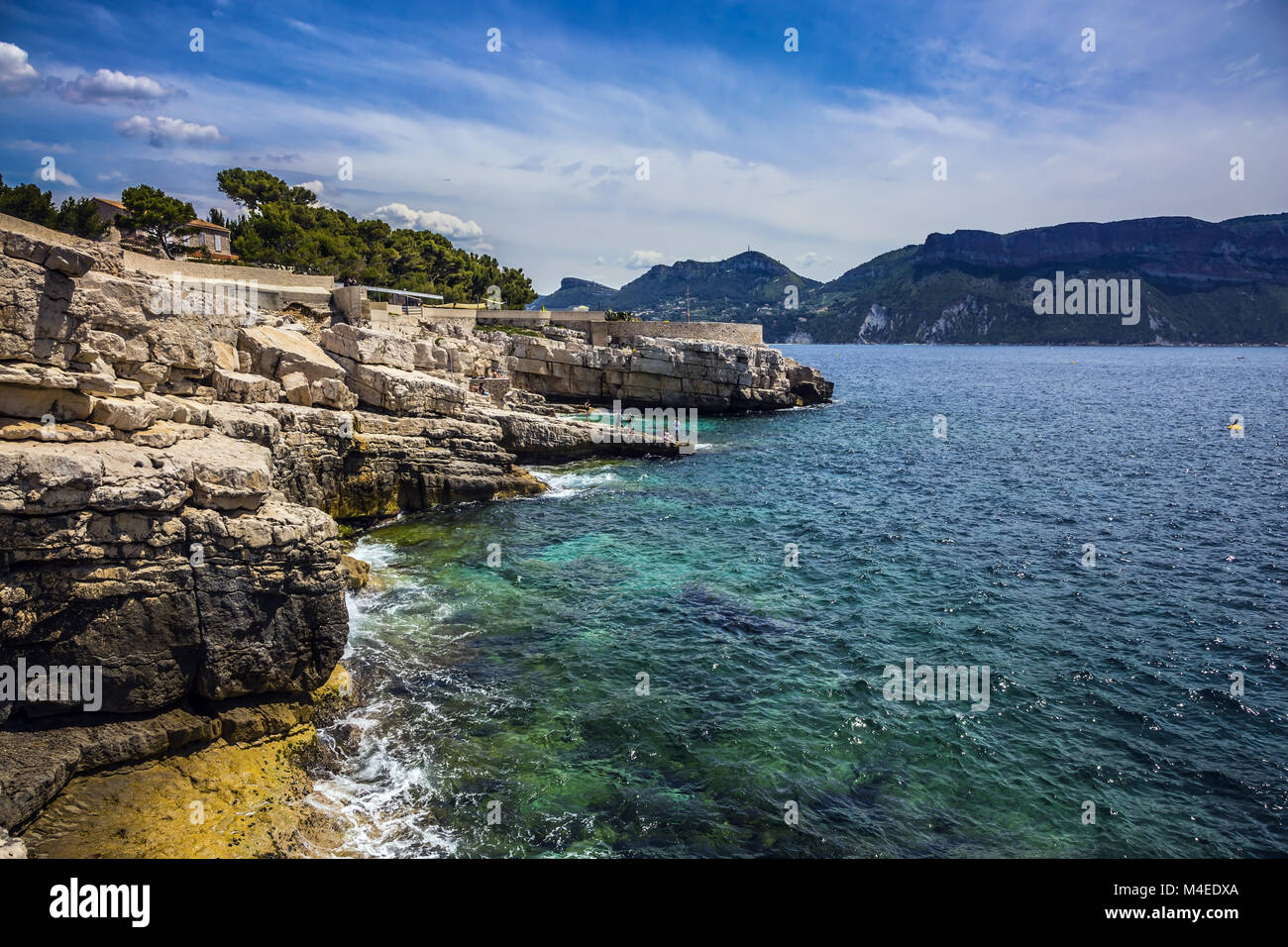 Abrupt stony coast and turquoise sea Stock Photo