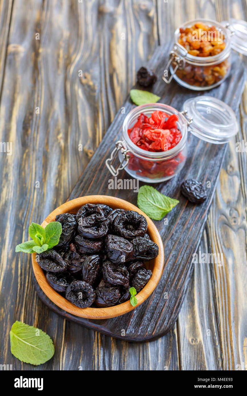 Wooden bowl with prunes. Stock Photo
